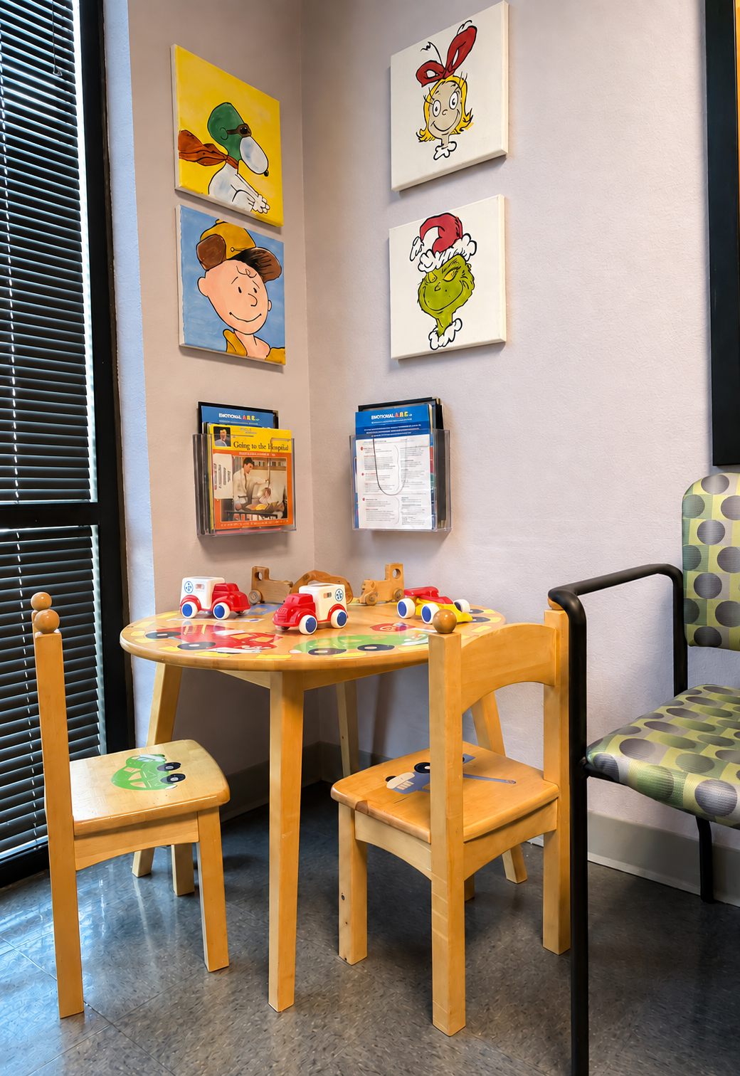 Children's play table with toys and books in the Evansville Primary Care waiting area.