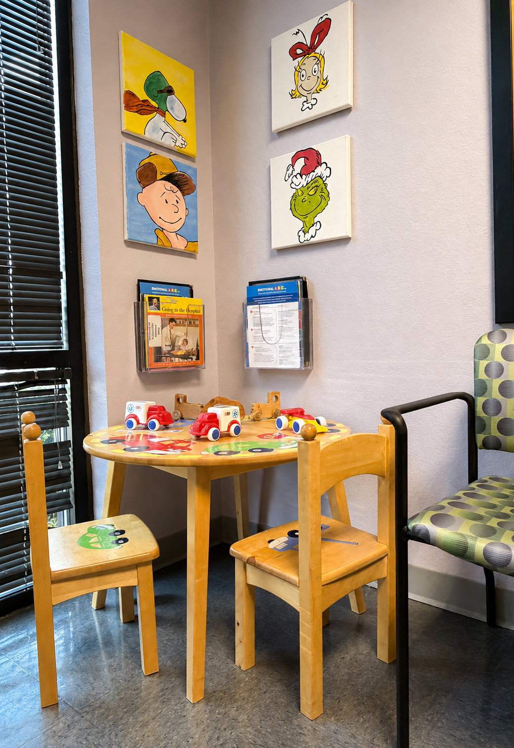 Children's play table with toys and books in the Evansville Primary Care waiting area.